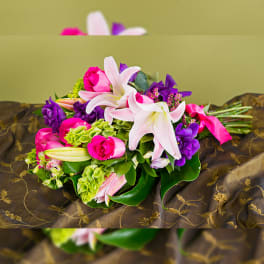 Bouquet of pink roses and white lilies with purple flowers