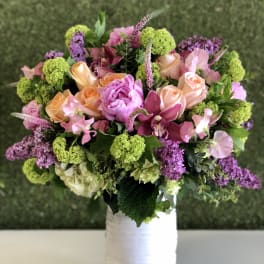 Bouquet of pink and peach flowers in a white vase