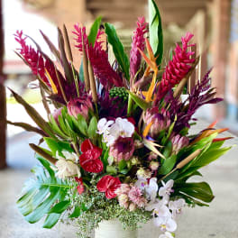 Tropical bouquet in a white vase with pink and white orchids