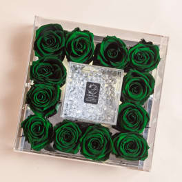Green roses arranged in a clear square box with a crystal center