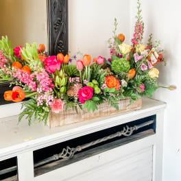 Colorful mixed flower arrangement in a rectangular wooden box