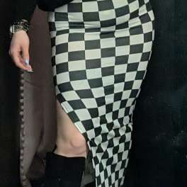 Person wearing a black-and-white checkered skirt and black boots