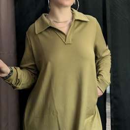 Person wearing an olive-green collared dress with long sleeves