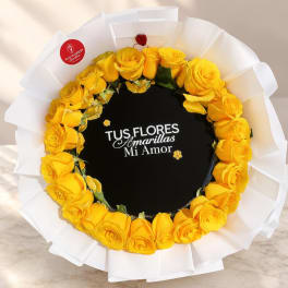 Round bouquet of yellow roses wrapped in white paper
