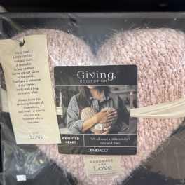 Pink knitted heart-shaped gift in a box with a comfort message tag