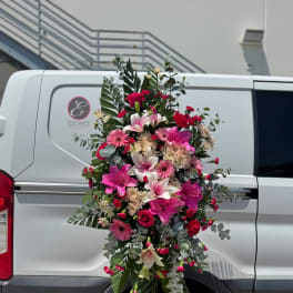 Tall pink and white floral spray with lilies and daisies