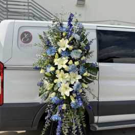 Tall blue and white floral spray on a stand
