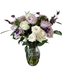 Bouquet of white and pale lavender roses in a glass vase