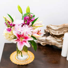 Pink lilies and chrysanthemums in a glass vase