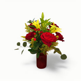 Red roses and yellow lilies in a red vase