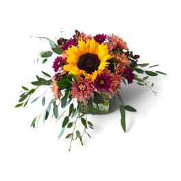 Sunflower and chrysanthemum arrangement in a glass vase