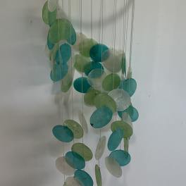 Hanging mobile with teal, green, and white discs on strings from a bamboo ring