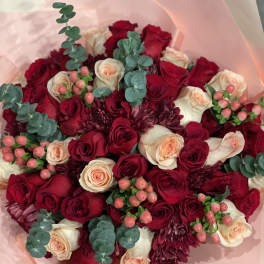 Bouquet of red and cream roses with burgundy blooms and eucalyptus