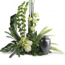 Green floral arrangement with a dark urn