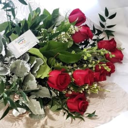 Bouquet of red roses with silver foliage and pink ribbon