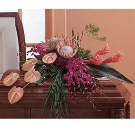 Tropical floral spray with pink orchids and protea on a casket