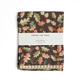 Folded tea towel with an oak leaf and acorn pattern