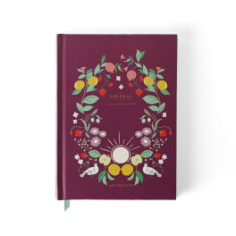 Maroon journal with a floral fruit wreath cover design