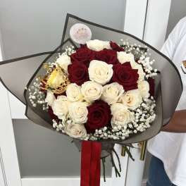 Bouquet of red and white roses with baby's breath and a gold crown