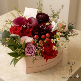 Heart-shaped box of red, pink, and white flowers