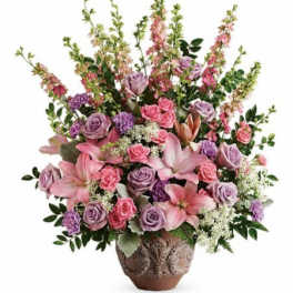 Pink and lavender floral arrangement in a decorative vase