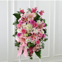 Pink and white floral standing spray with lilies and roses on an easel