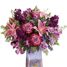 Pink and purple bouquet in a tall iridescent vase