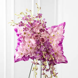 Pink and purple floral standing spray on an easel