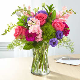 Mixed pink and purple bouquet in a clear glass vase