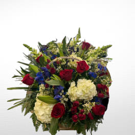 Bouquet of red roses, white hydrangeas, and blue flowers