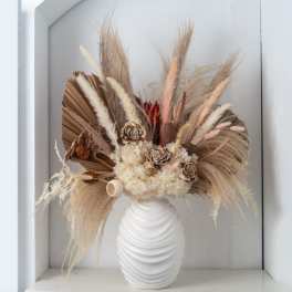 Neutral dried flower arrangement with pampas and wood flowers in a white ribbed vase