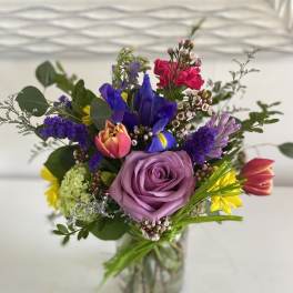 Mixed bouquet with a lavender rose in a glass vase