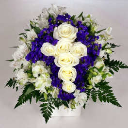 White roses and purple flowers in a white vase