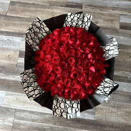 Large bouquet of red roses wrapped in black and white paper