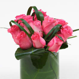 Pink roses arranged in a clear glass vase