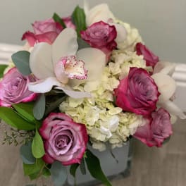 Bouquet of pink roses, white orchids, and pale hydrangeas