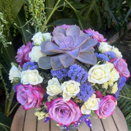 Bouquet of pink and white roses with a purple succulent centerpiece