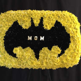 Yellow chrysanthemum funeral tribute with the word MOM in the center