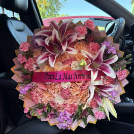 Large bouquet of pink and peach roses with lilies and carnations