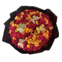 Bouquet of red and yellow roses with decorative butterfly picks