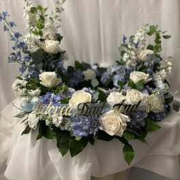 Floral wreath with white roses, blue flowers, and a gold "Beloved Dad" sign