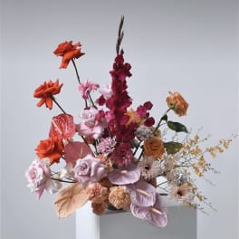 Tall mixed bouquet with orange, pink, and burgundy flowers