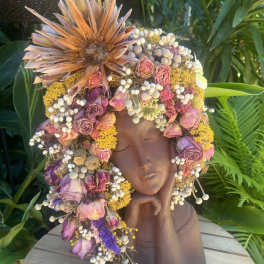 Floral crown on a sculpted bust with pink and purple dried flowers