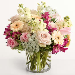 Pink and cream mixed bouquet in a clear glass vase