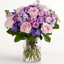 Pink and purple mixed bouquet in a clear glass vase