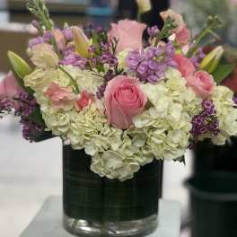 Pink roses and white hydrangeas in a glass vase
