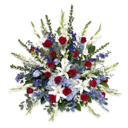 Large bouquet of red roses, white lilies, and blue flowers