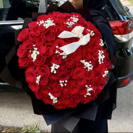 Large bouquet of red roses with white baby's breath and a white ribbon