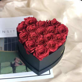 Heart-shaped box filled with red roses