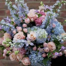Pastel bouquet of roses, hydrangeas, and lavender flowers